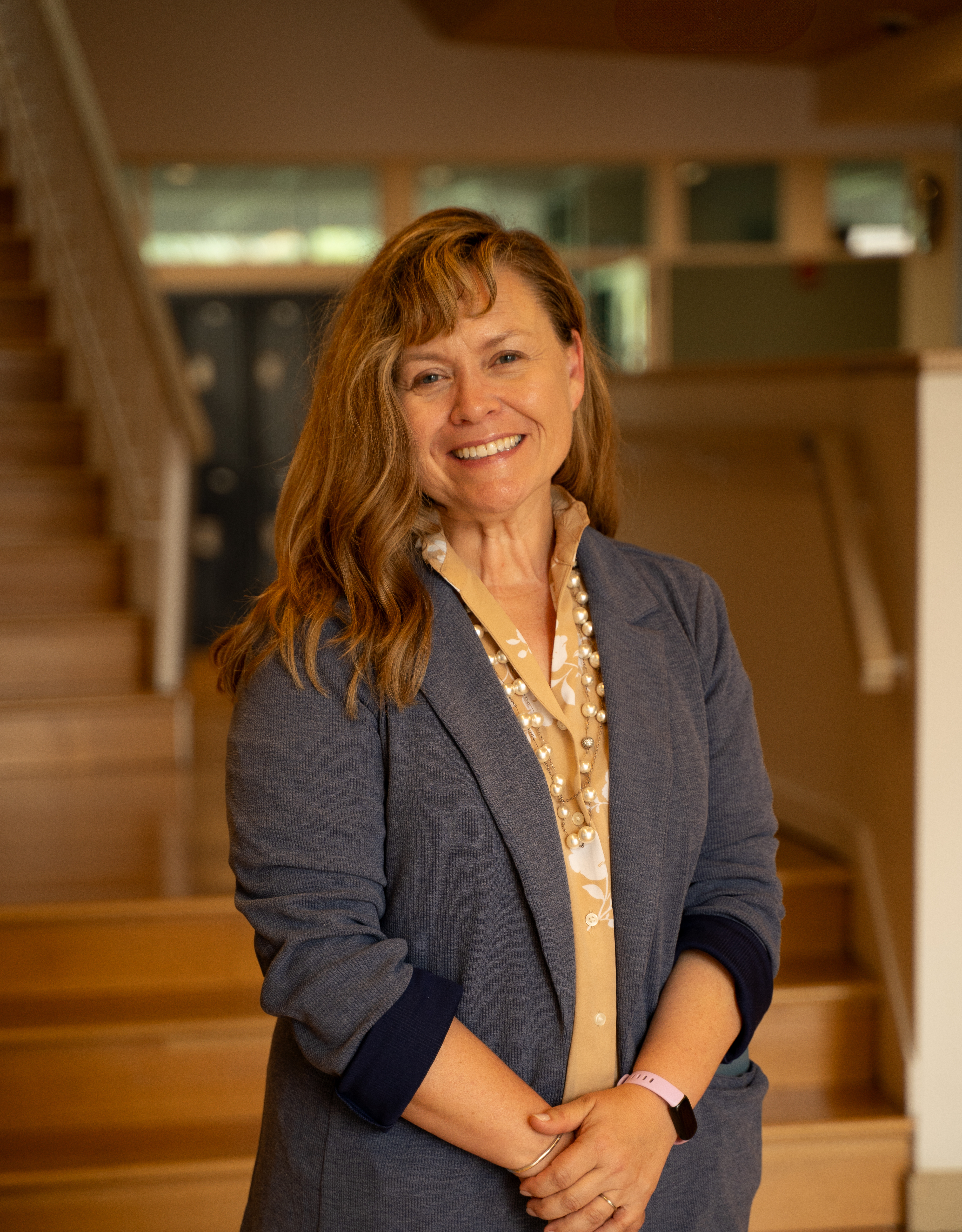A teacher in the classroom helping the student at the desk